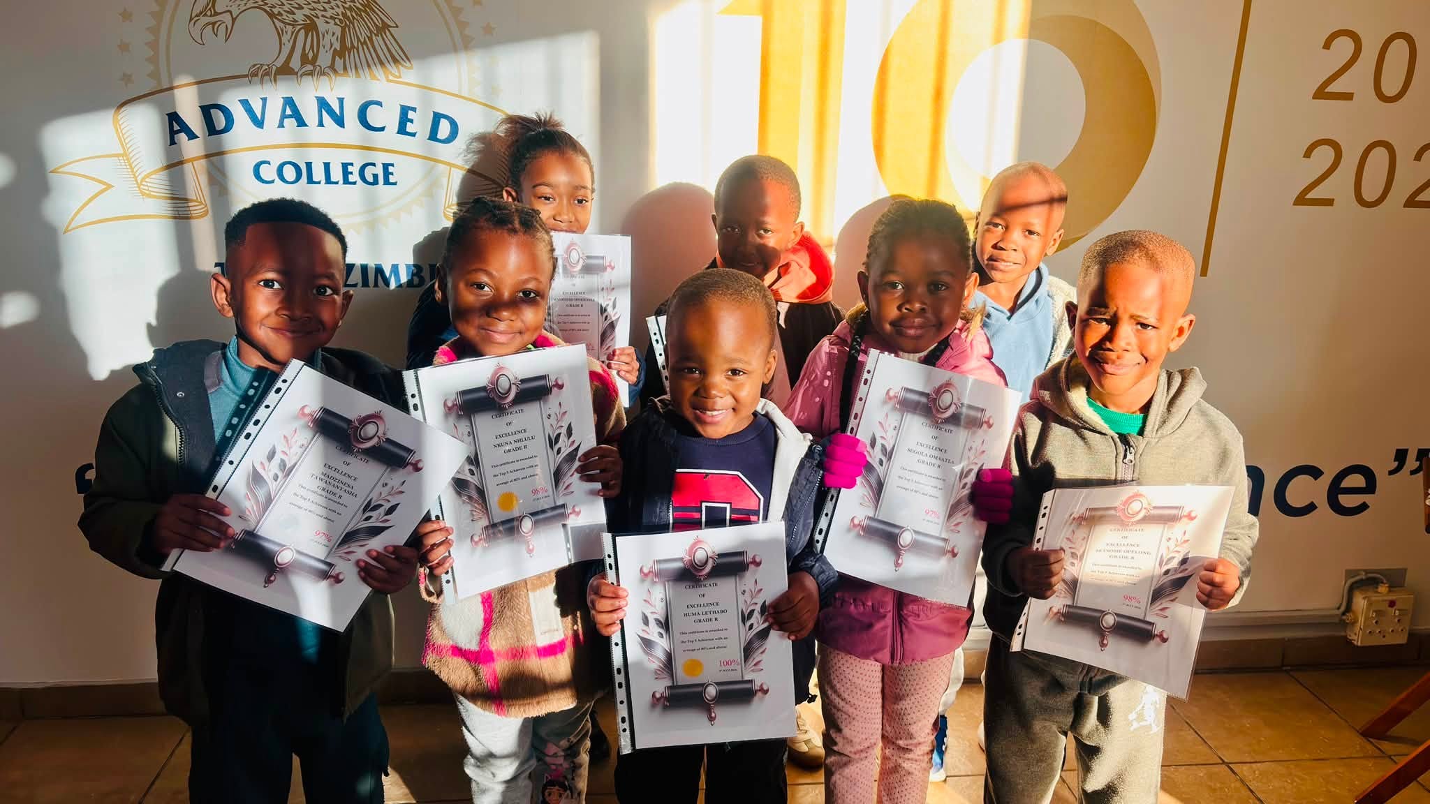 Advanced College learners holding achievement certificates