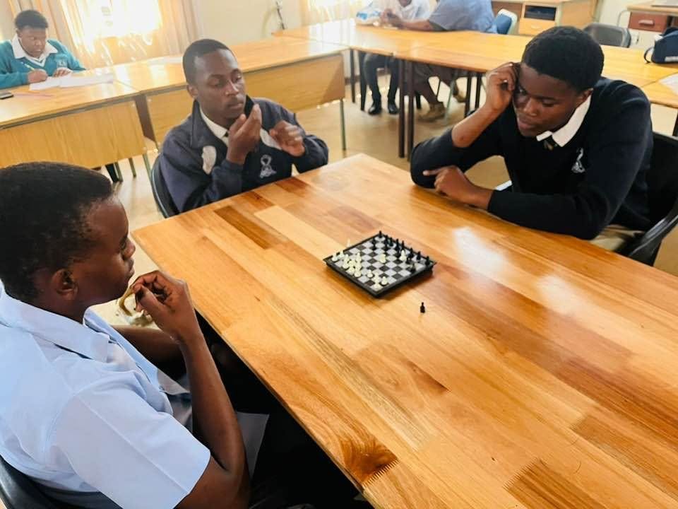 Advanced College learners playing chess in a classroom