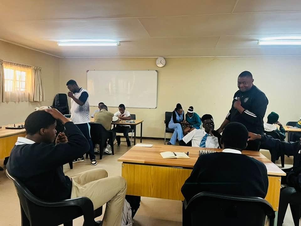 Advanced College learners gathered during a chess activity
