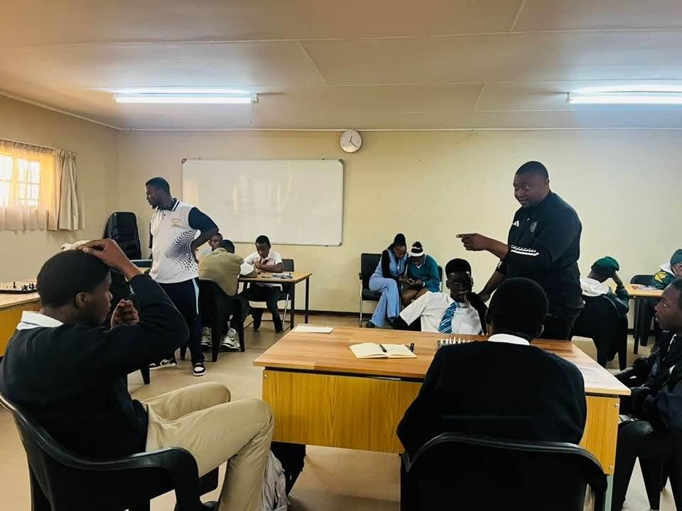 Advanced College learners taking part in a classroom chess activity