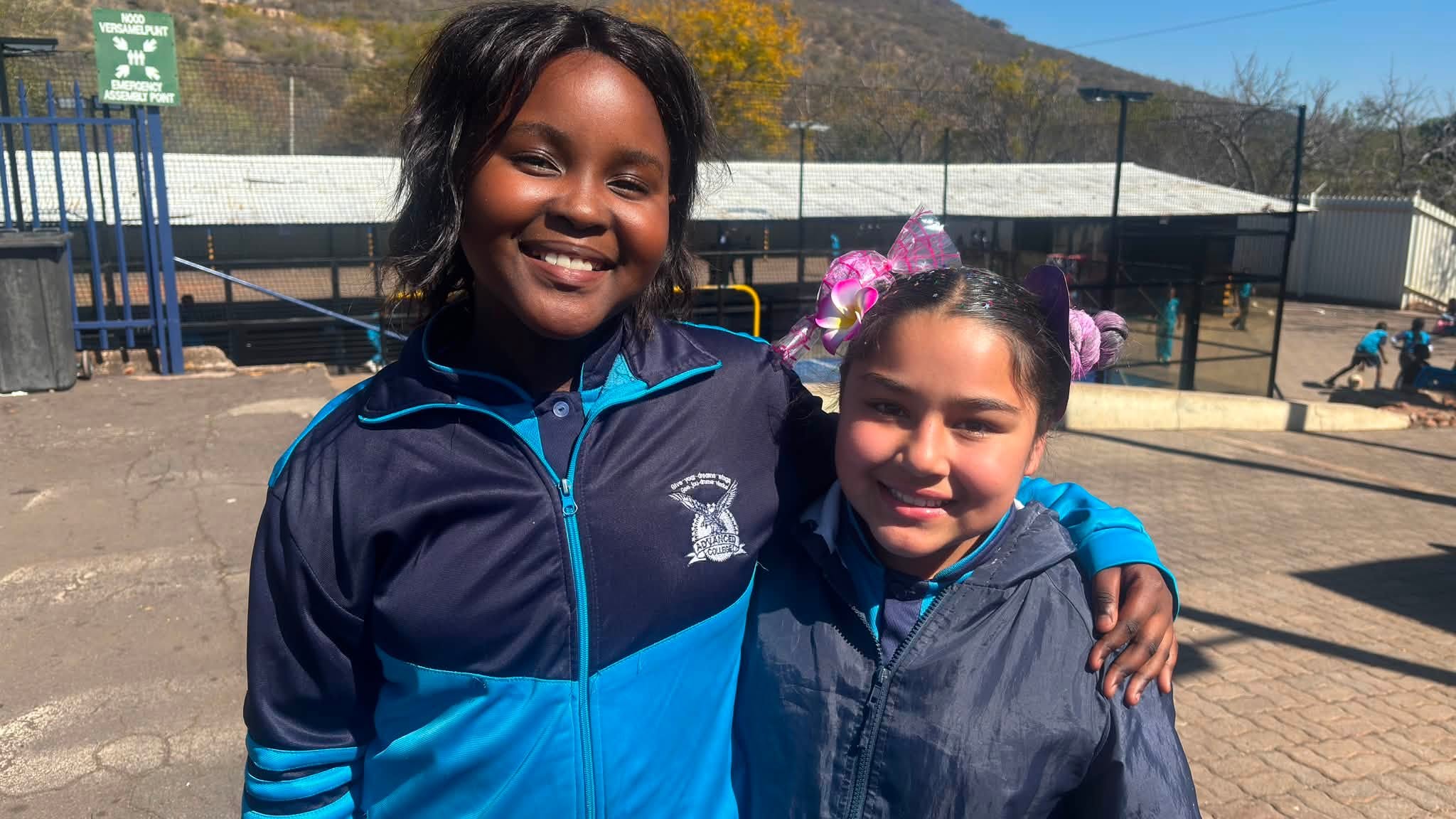 Advanced College learners together outdoors in school sportswear