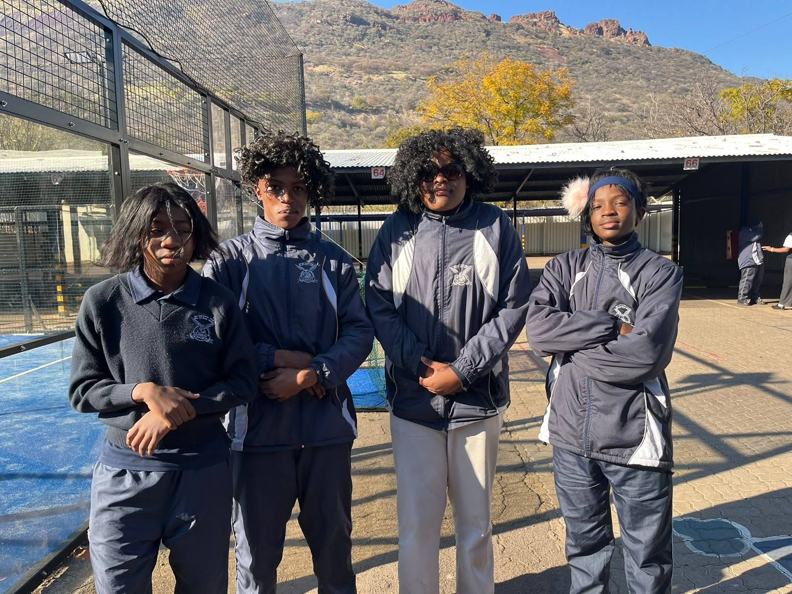 Advanced College learners standing together in school sportswear