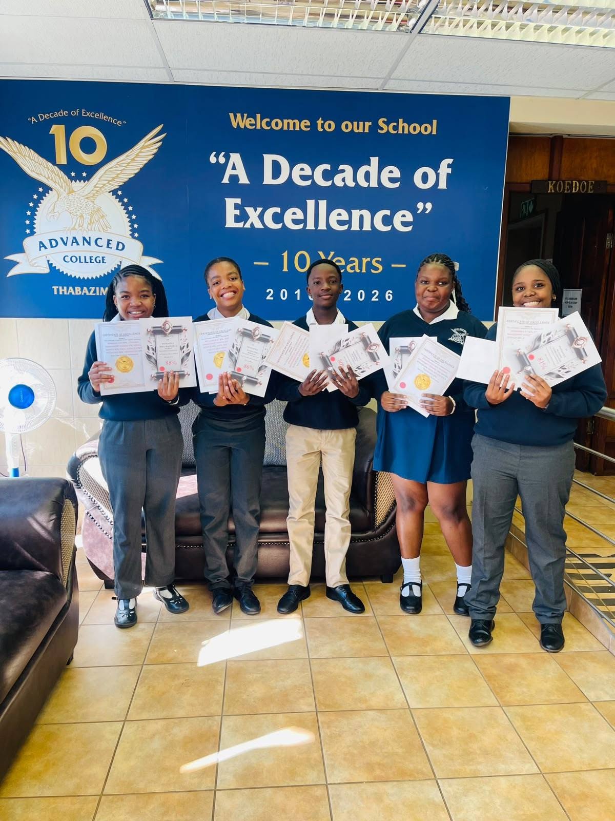 Advanced College learners holding achievement certificates